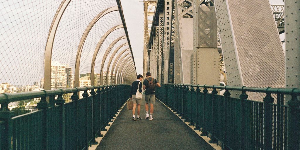 people walking on gray concrete bridge during daytime