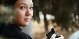a woman holding a camera in her hands