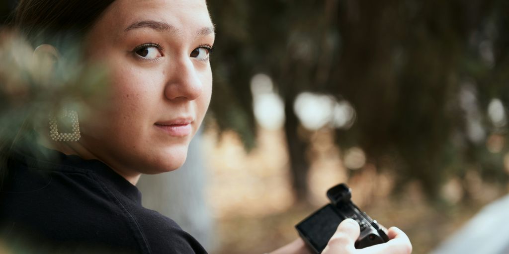 a woman holding a camera in her hands