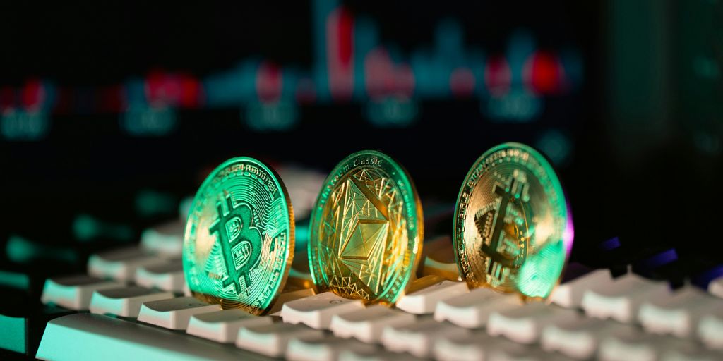 Cryptocurrency coins sit on a keyboard.