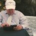 a man sitting on a bench looking at his cell phone