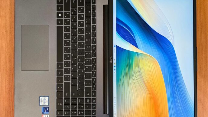a laptop computer sitting on top of a wooden table