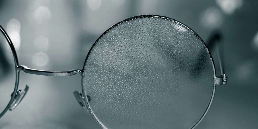 a pair of glasses sitting on top of a table