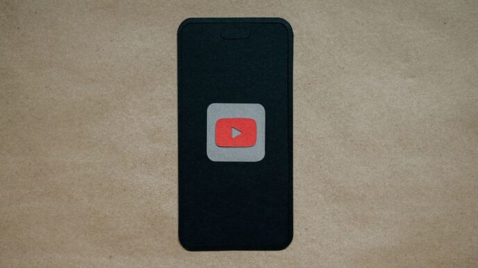 a black cell phone with a red youtube logo on it