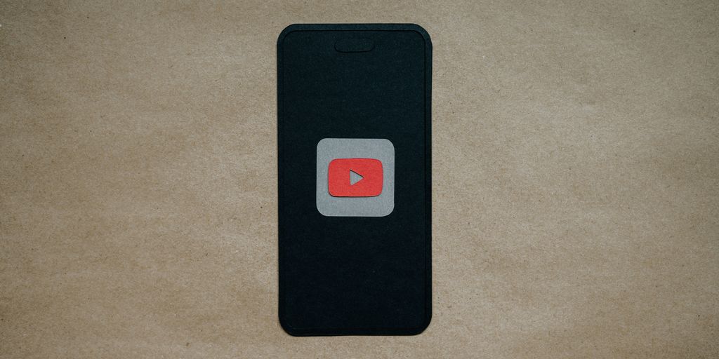 a black cell phone with a red youtube logo on it