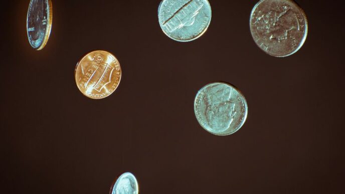 silver round coins on white surface