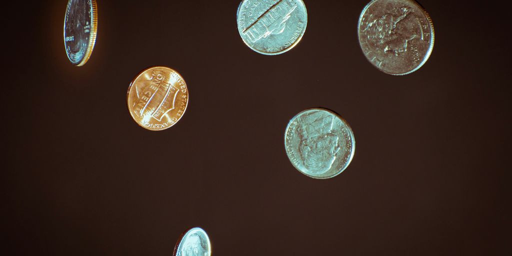 silver round coins on white surface