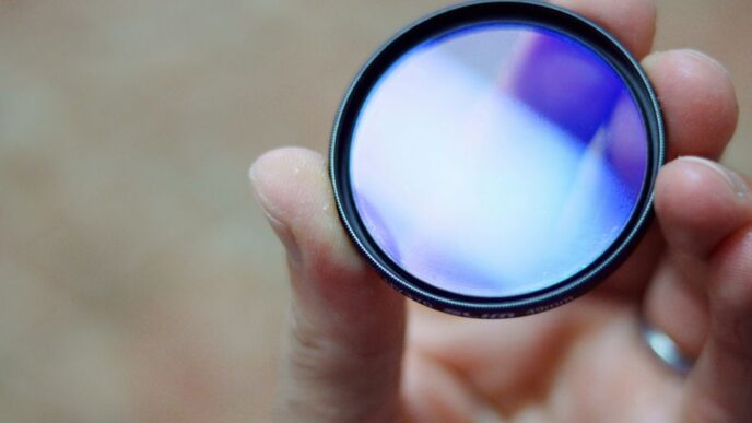 person holding round black and white lens
