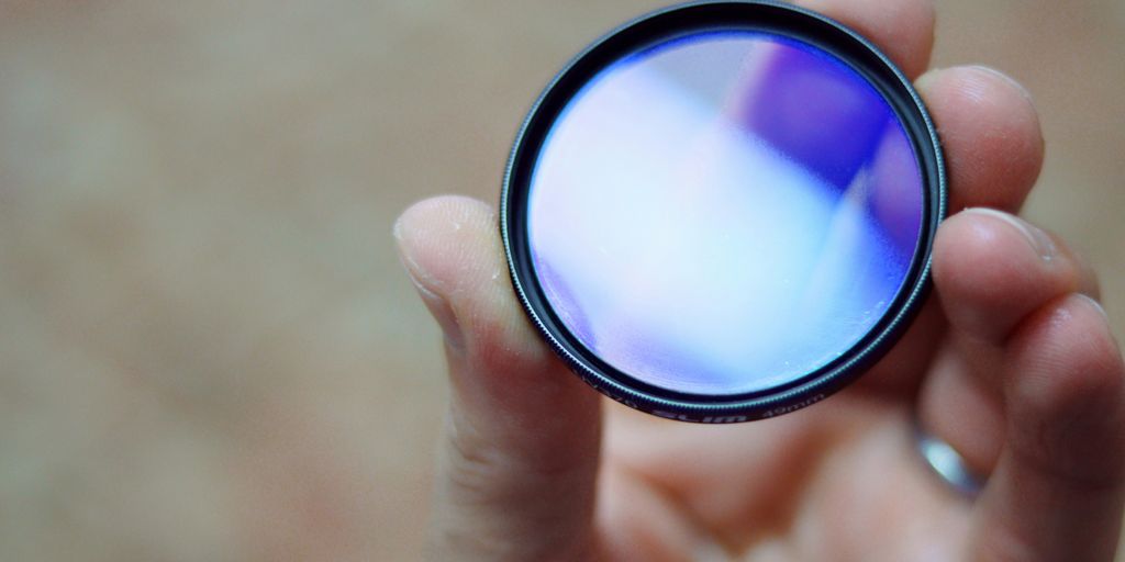 person holding round black and white lens
