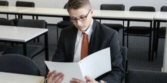 man holding folder in empty room