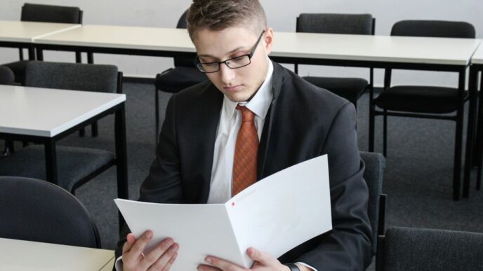 man holding folder in empty room