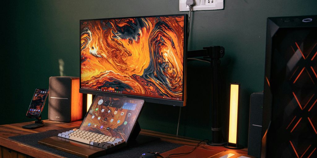 a desk with a laptop and a monitor on it