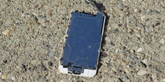a broken cell phone laying on the ground