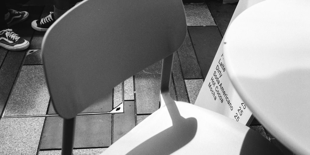 a white chair sitting on top of a tiled floor