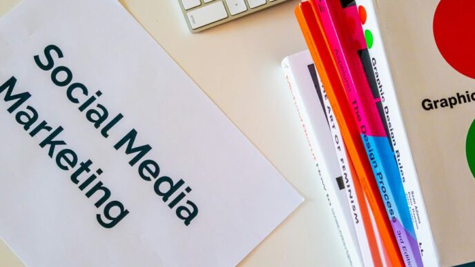 a sign that says social media marketing next to a keyboard