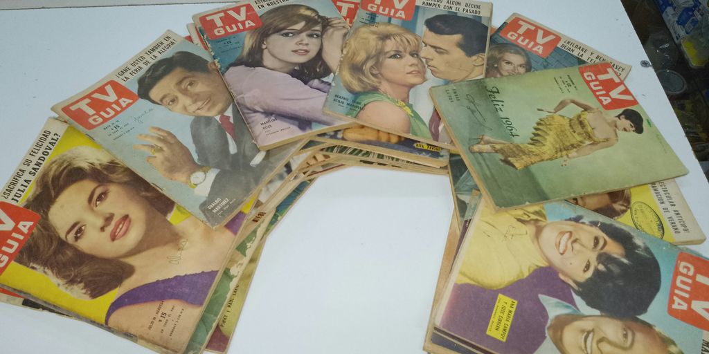 a bunch of magazines sitting on top of a table