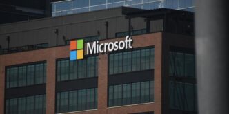 A tall building with a microsoft logo on top of it