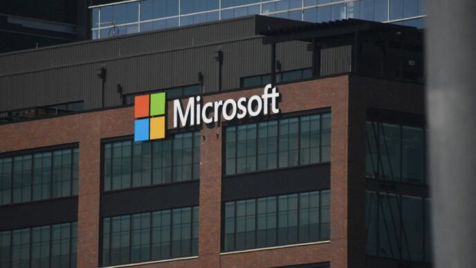 A tall building with a microsoft logo on top of it