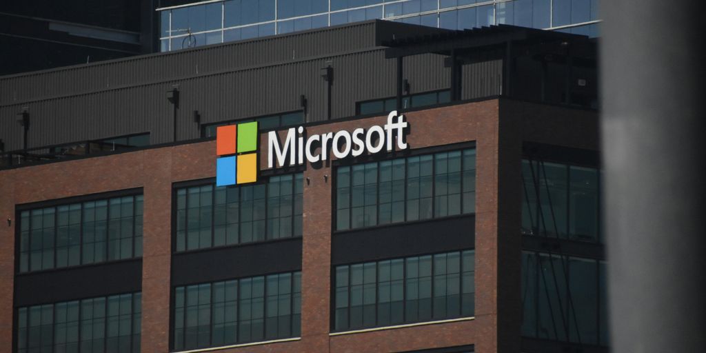 A tall building with a microsoft logo on top of it