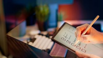 Someone is writing on a tablet with a stylus.