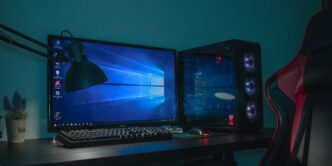 turned on desktop computer set with black and gray leather gaming chair
