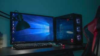 turned on desktop computer set with black and gray leather gaming chair