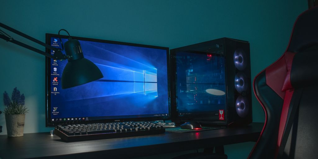 turned on desktop computer set with black and gray leather gaming chair
