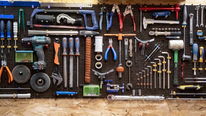 A bunch of tools hanging up on a wall