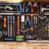 A bunch of tools hanging up on a wall