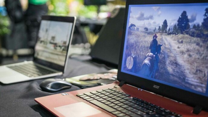 a couple of laptops sit on a table