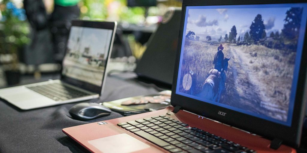 a couple of laptops sit on a table