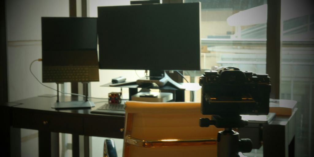 a camera sitting on top of a chair next to a window