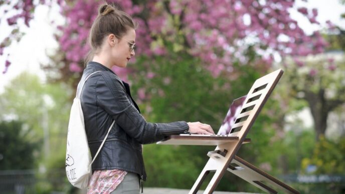 girl in black jacket and pink pants standing on white chair