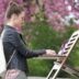 girl in black jacket and pink pants standing on white chair