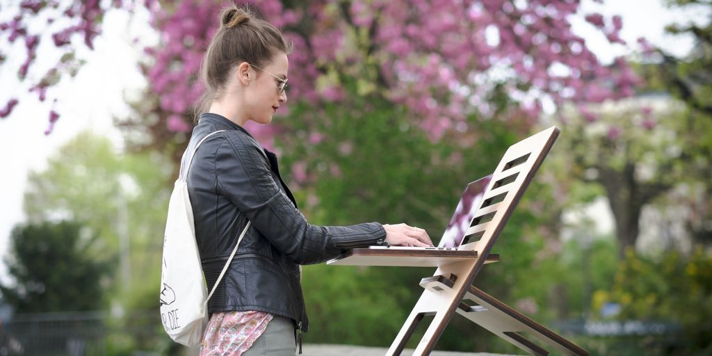 girl in black jacket and pink pants standing on white chair