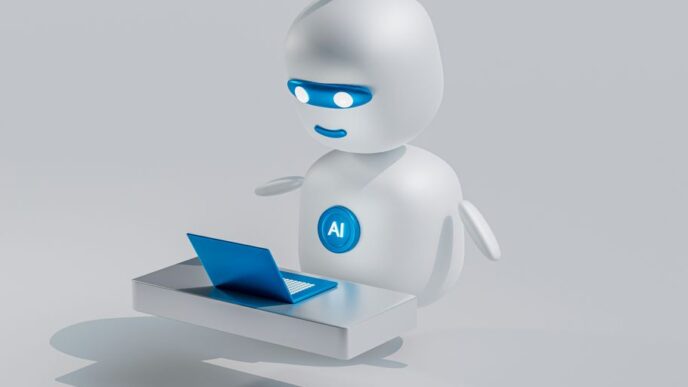 a white robot with blue eyes and a laptop