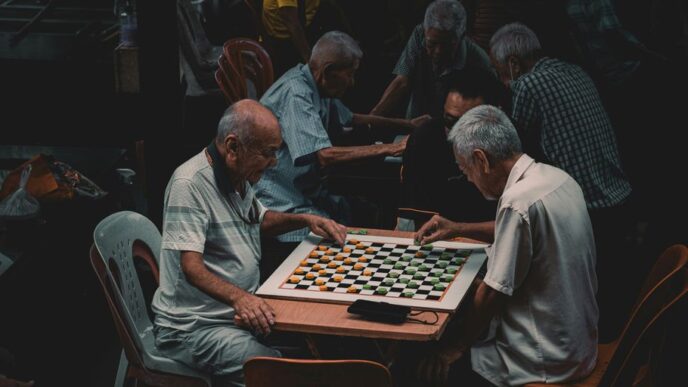 a group of older men playing a game of chess