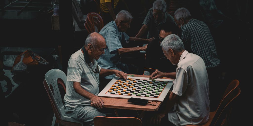 a group of older men playing a game of chess