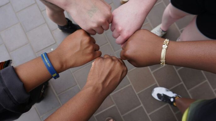 A group of people putting their hands together