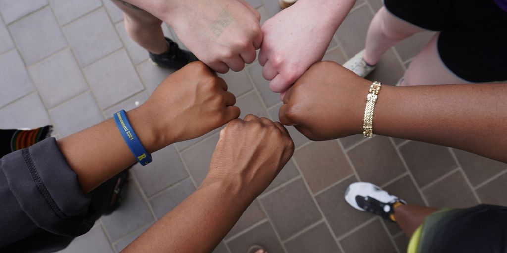 A group of people putting their hands together