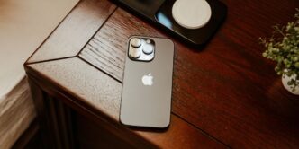 an iphone is sitting on a wooden table