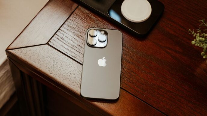 an iphone is sitting on a wooden table