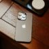 an iphone is sitting on a wooden table