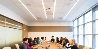 people having meeting on rectangular brown table