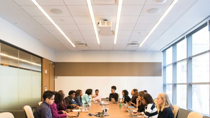 people having meeting on rectangular brown table