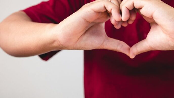a person making a heart with their hands