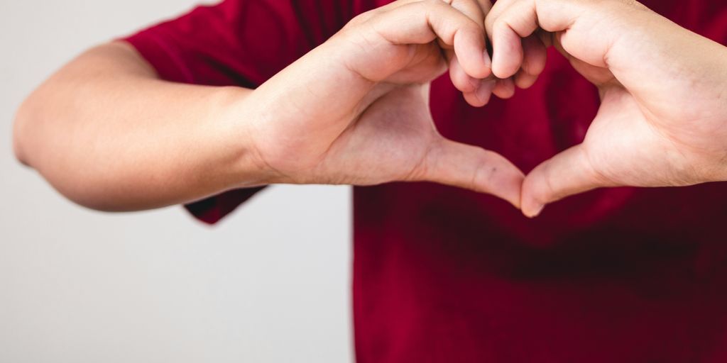 a person making a heart with their hands
