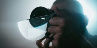 person holding black camera lens