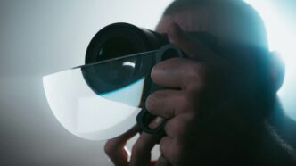 person holding black camera lens