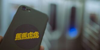 a person holding a cell phone in their hand